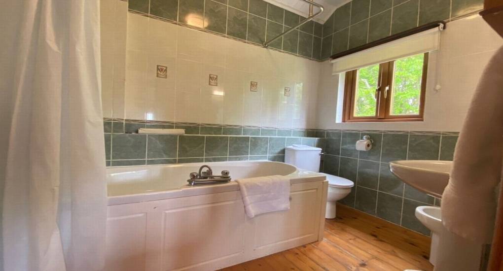 bathroom with bath and shower and toilet