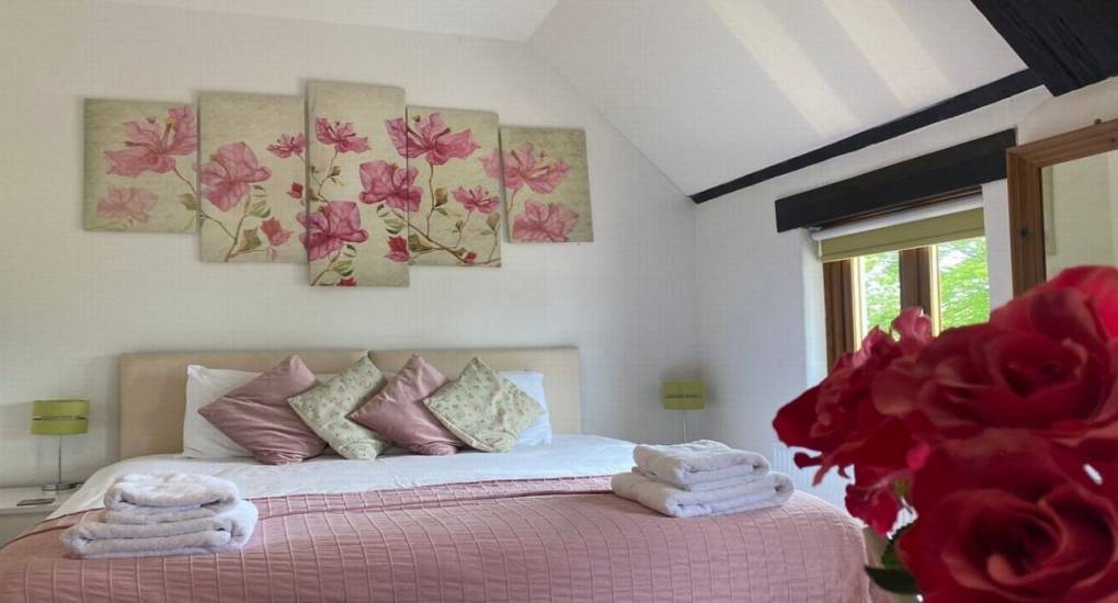 pink themed bedroom with roses and wall art