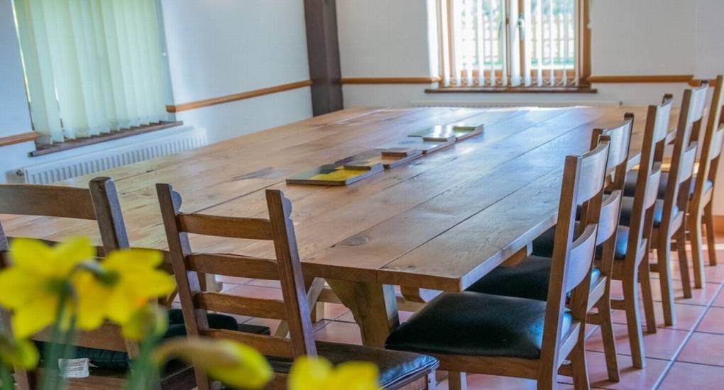 large wooden dining table with chairs