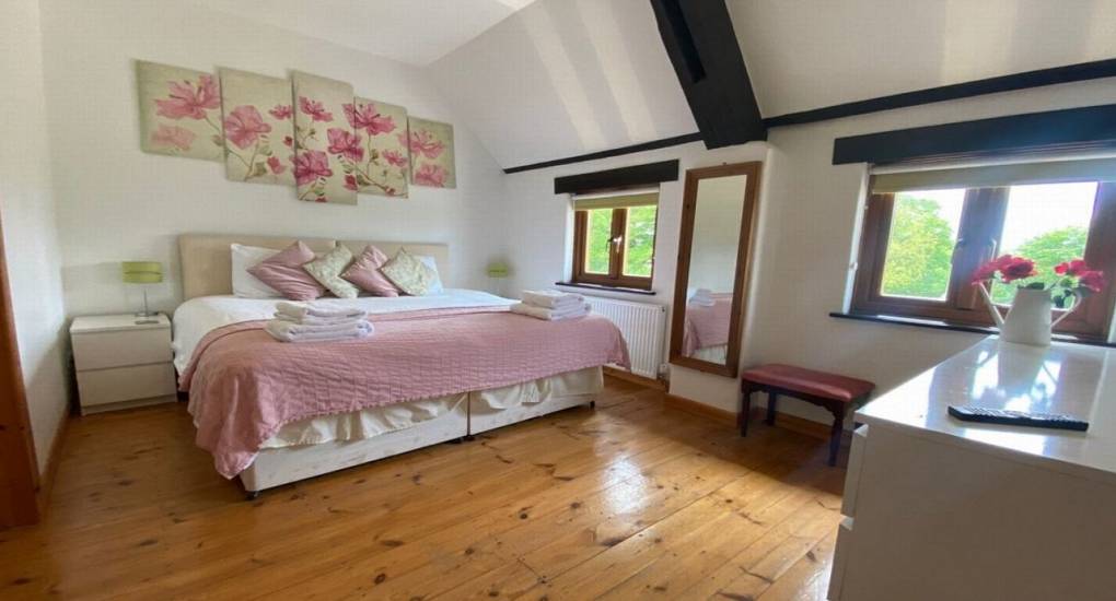 pink bedroom with wooden floors