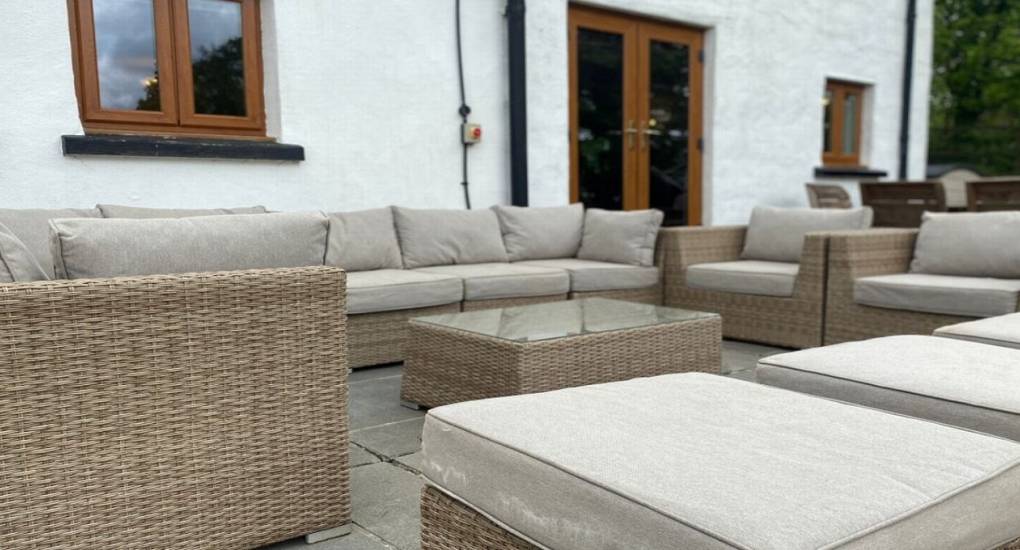 outdoor sofa area with glass table