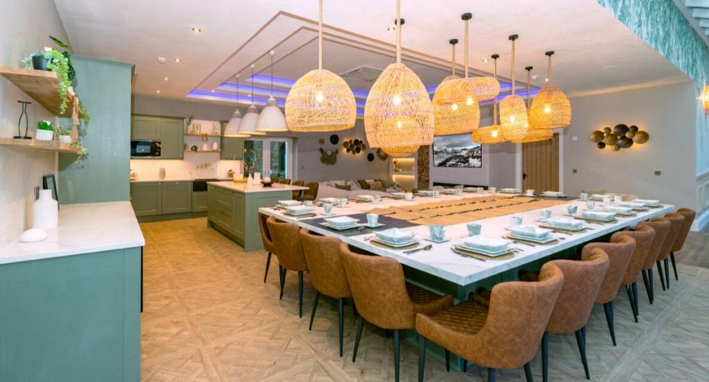 Large set dining table with kitchen in the background