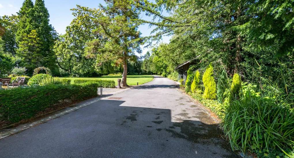 Driveway to the property showing well manicured grounds