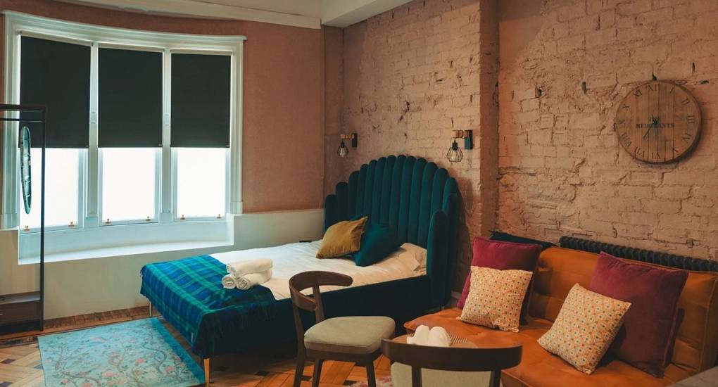 Stylish bedroom at Extravagance Edinburgh with a large double bed and contemporary decor, part of our luxury Edinburgh hen do apartments in the Leith district.