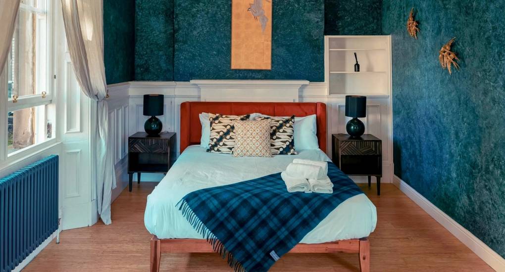 Stylish open-plan reception and social area at Extravagance Edinburgh, offering high-end Edinburgh stag do accommodation with modern interiors and group seating.