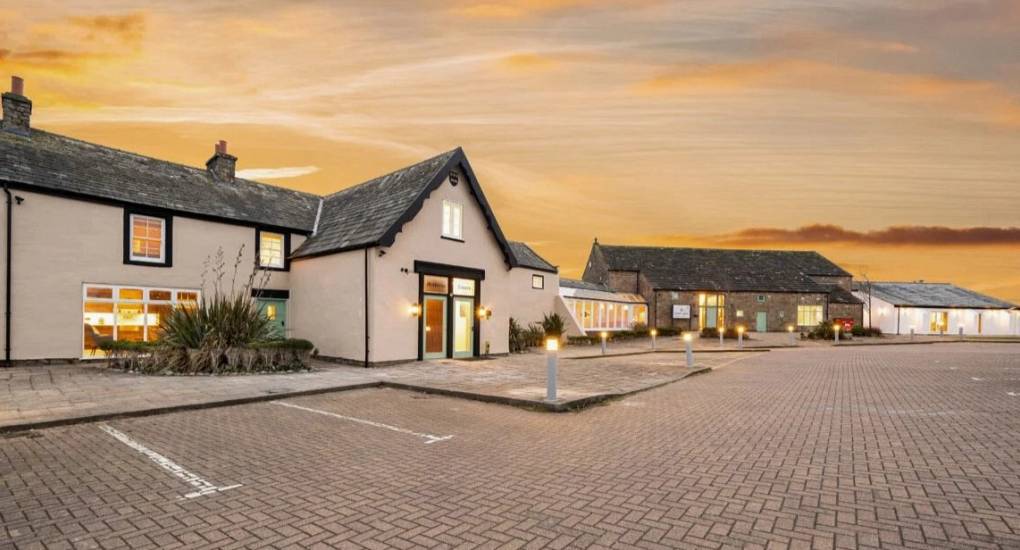 The front of the Cave Spa in Morecambe Bay at dusk with lighting