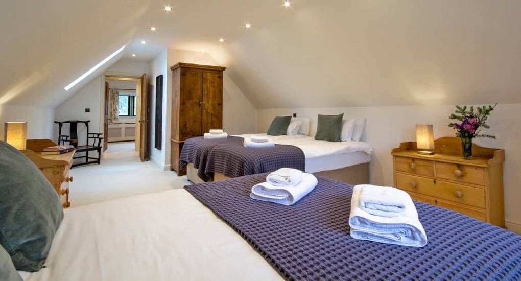 Spacious triple room at Godfrey Manor luxury hen house, showing flexible bed options for large parties.