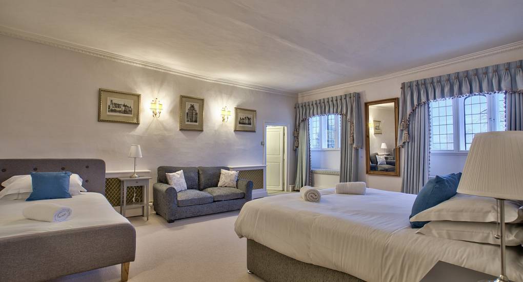Large bedroom with double bed single bed and sofa