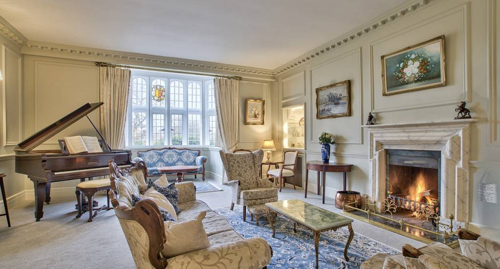 Piano room with lit fire place