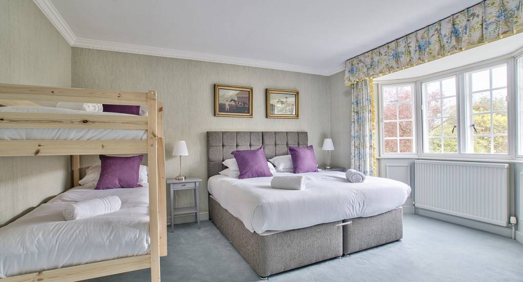 Double bed and bunk bed with pink pillows 