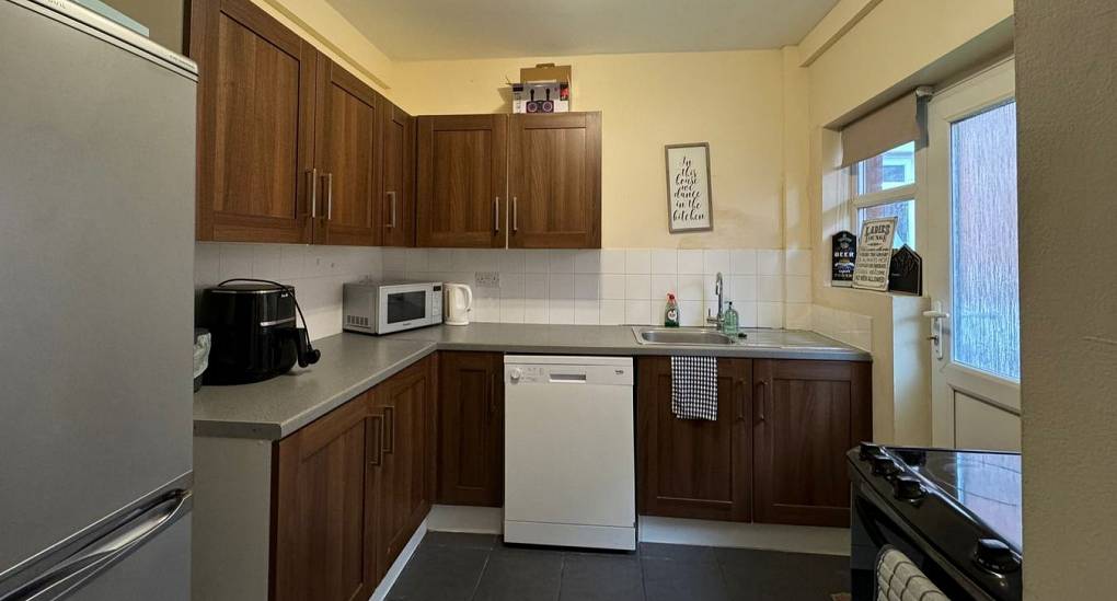 View of kitchen with fridge and freezer