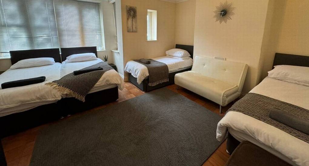 large bedroom with 4 single beds