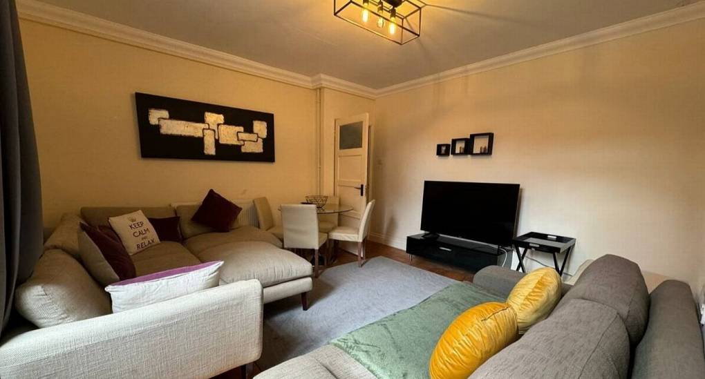 Lounge with corner sofa and 3 seater sofa and TV