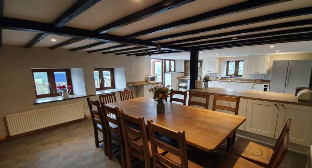 wooden beam ceiling dining area with kitchen