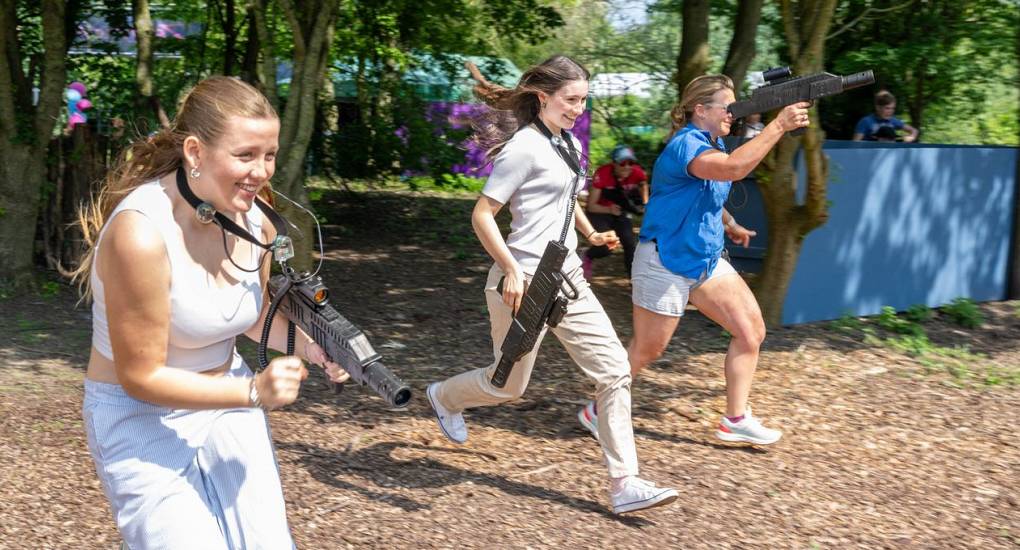 Three hens running during laser tag