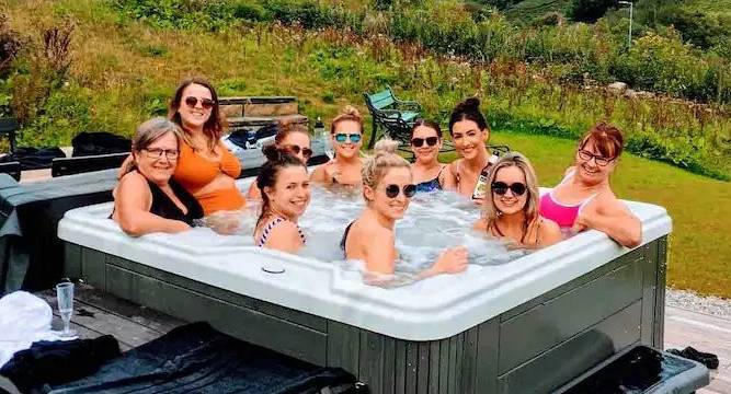 Hen group enjoying the hot tub at the Canals Manchester hen do accommodation