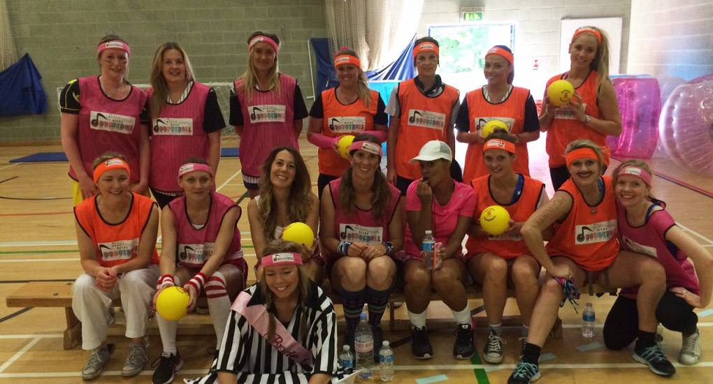 Hen do pose for photo before playing dodgeball on their hen party
