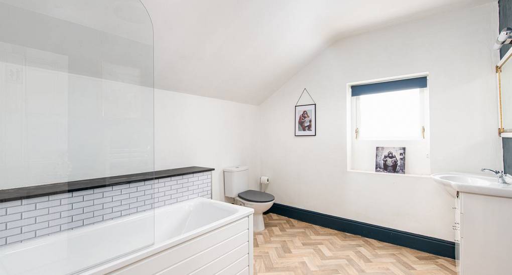 Family bathroom with shower over bath