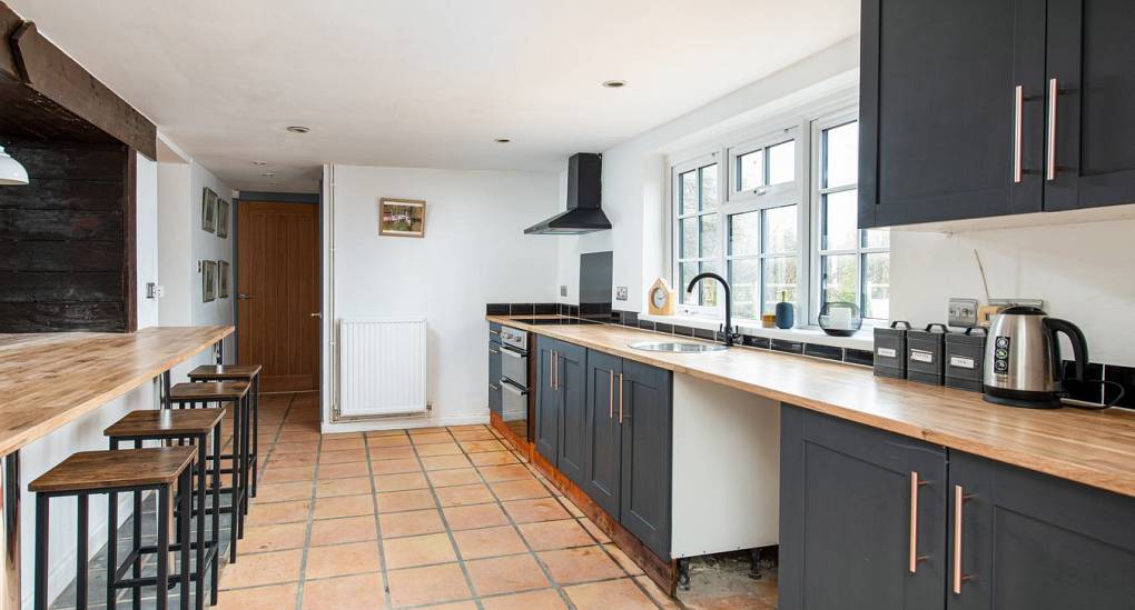 Kitchen with breakfast bar and table top in view