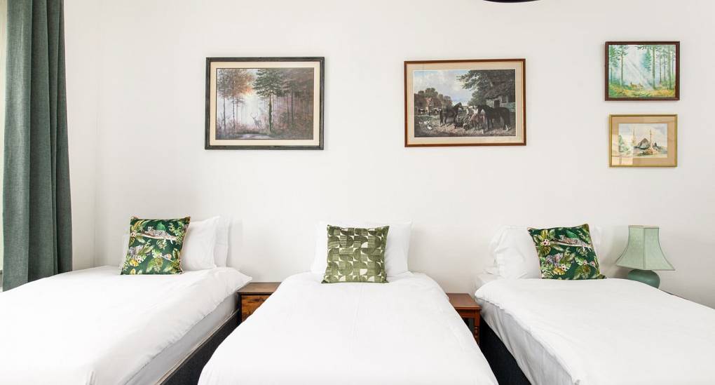 Three single beds with wall art