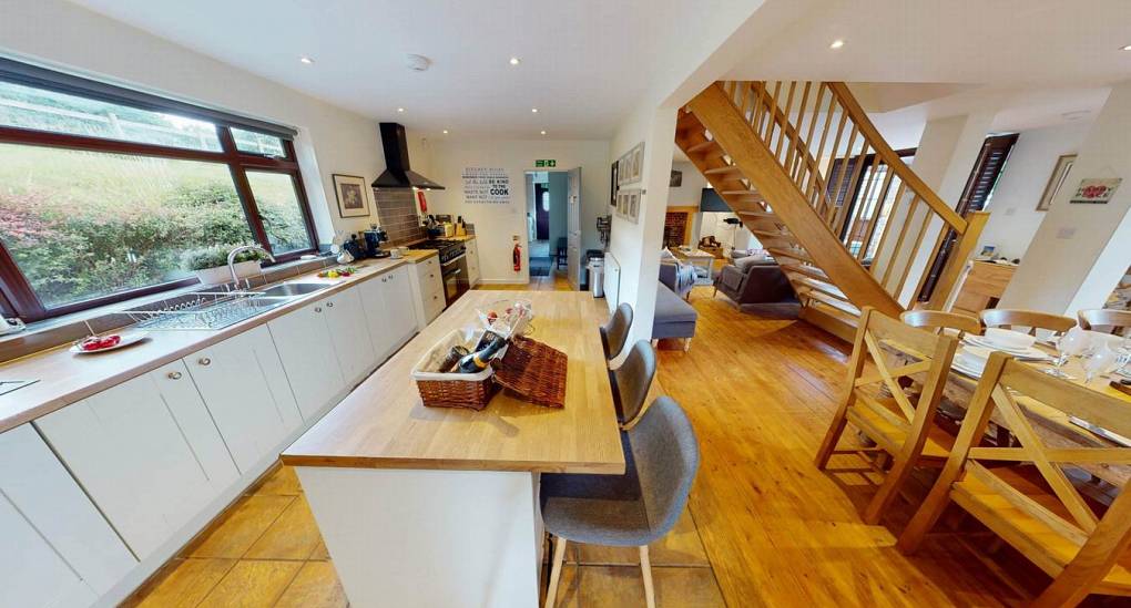 Kitchen view of breakfast bar and floating stairs 