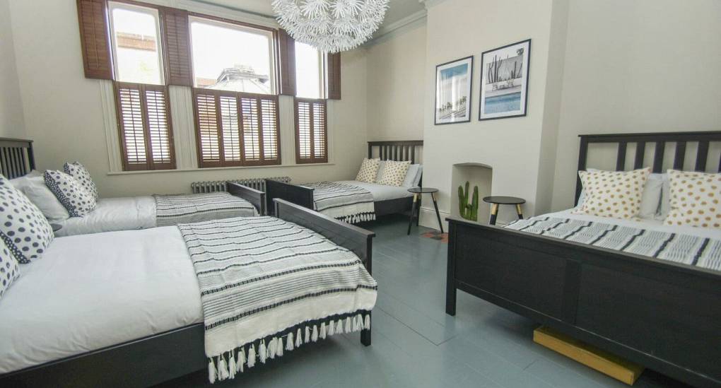 Large bedroom with four double beds