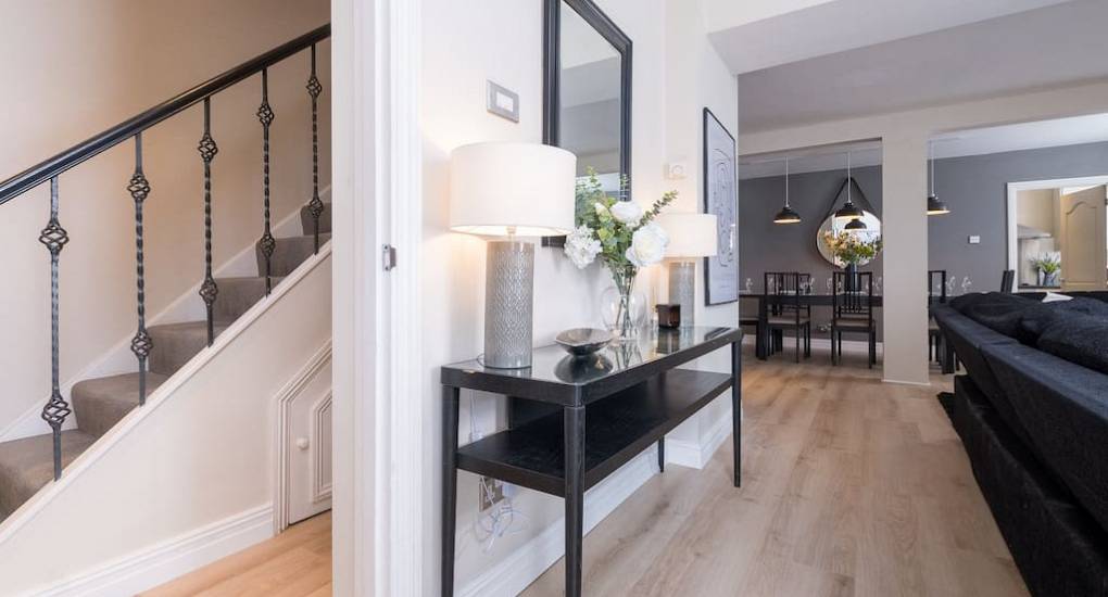 Hallway with table and stairs view