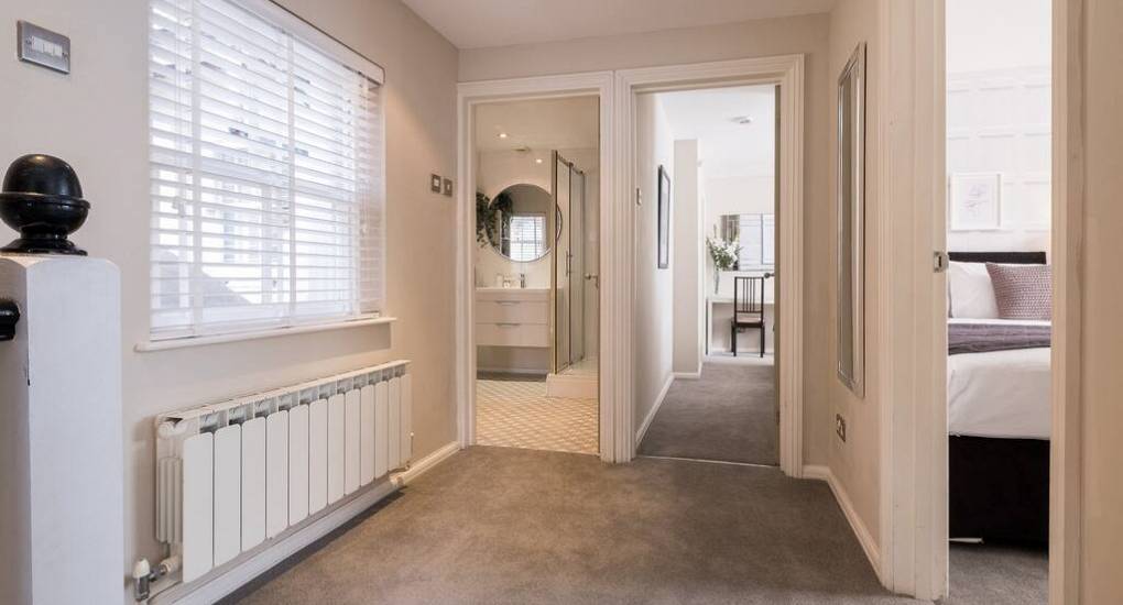 First floor hallway with view of two bedrooms 