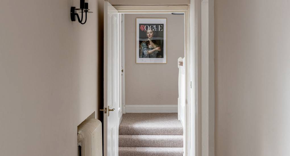 Hallway with stairs leading to bedrooms