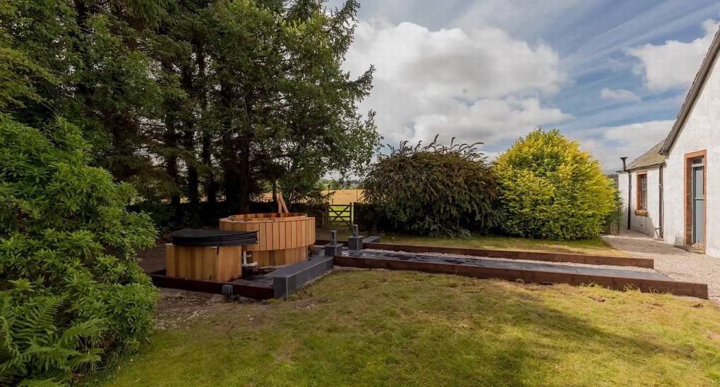 Large garden with hot tub along the path