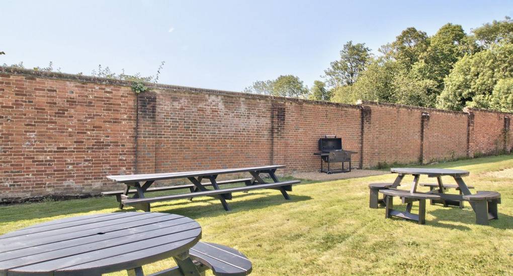 Private walled garden with bench seating