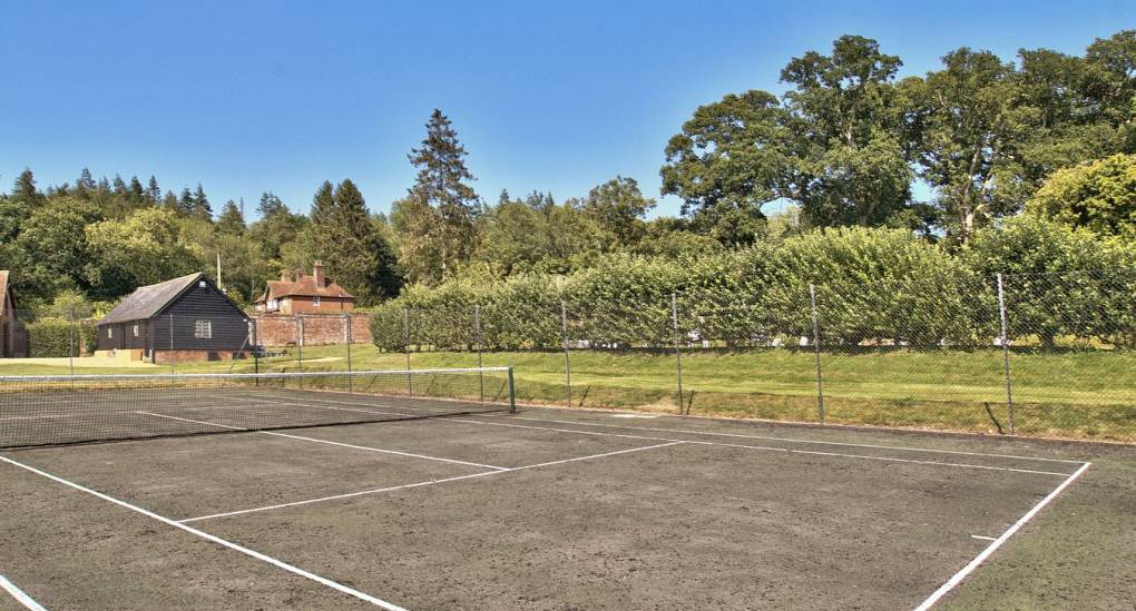 Private Tennis court in garden