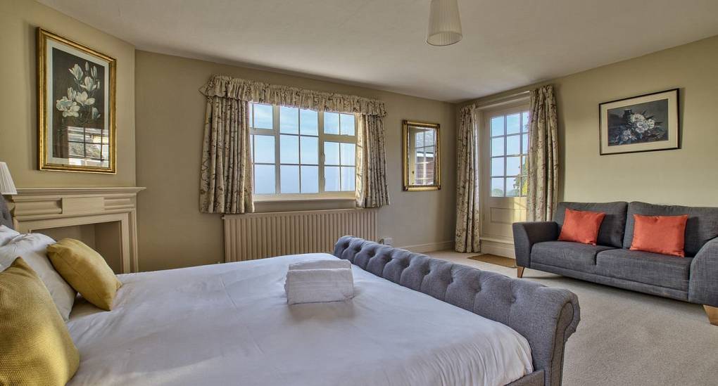Double bedroom with king bed and sofa