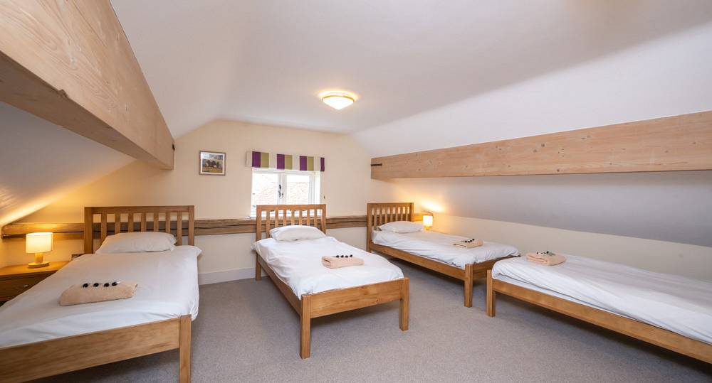 Quadruple bedroom with four single beds