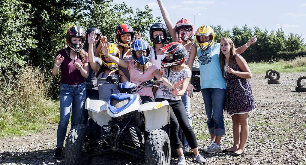 Hen party posing with quad bike