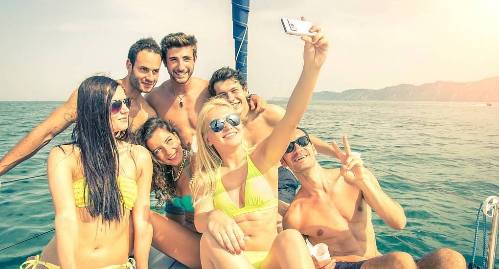 Group of friends enjoy chartering a boat