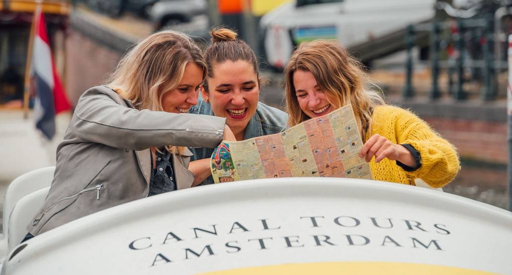 Hen group in Amsterdam looking for their next clue on their pedalo treasure hunt