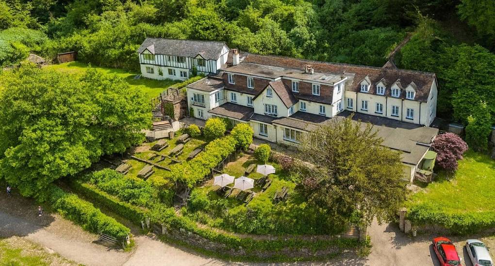 Aerial view of countryside lodge with outdoor garden seating at River View Lodge in Wye Valley.