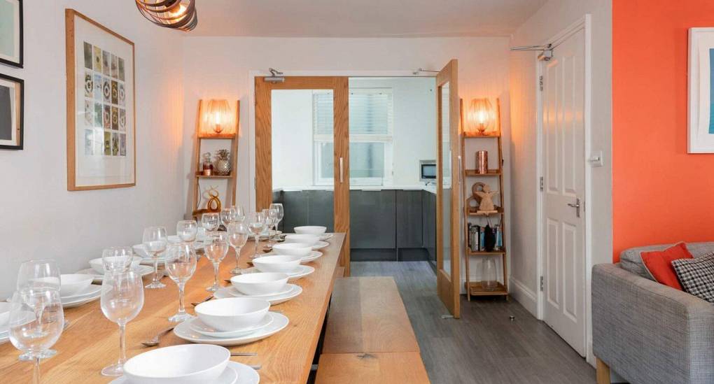 View down the dining table into the kitchen in iBrighton 