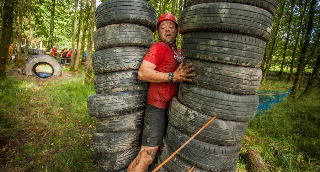 Stag squeezes through the tyre stack on the assault course