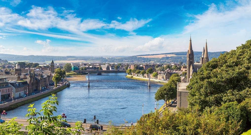 Horizon view of the River Ness in Inverness city centre, a top destination for Scottish stag party weekends.