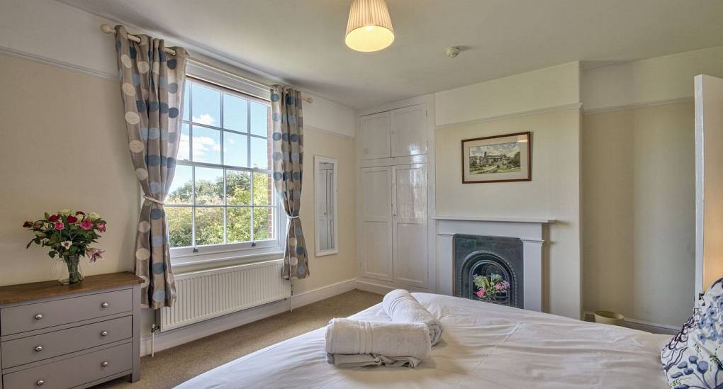 Double bed with fireplace next to window