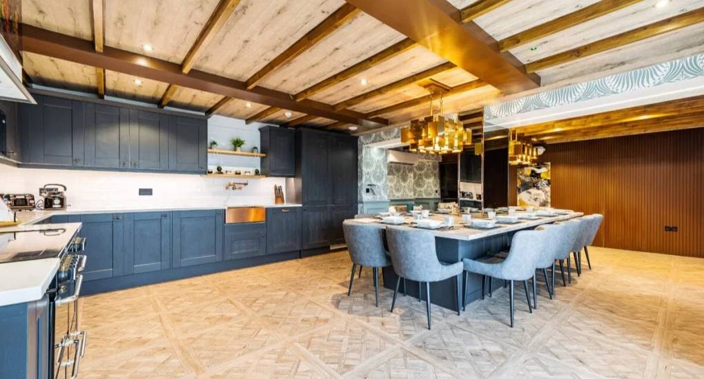 Kitchen and dining area with standard appliances and made up dining area ready to eat