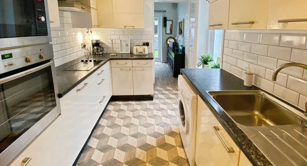 Well-equipped kitchen with modern appliances for self-catering at the Bournemouth Hot Tub Garden hen party house.