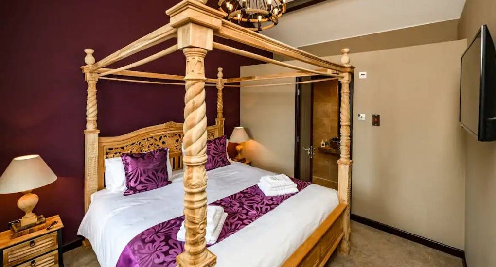 Four post bed in the master bedroom at the Rydal Pub Lake District Party House