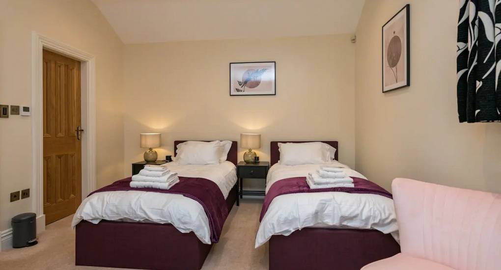 One of the four bedrooms showing made up twin beds ready for guests