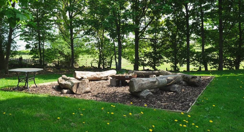 The large garden area has a handsome Firepit area