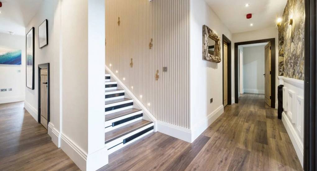 Large modern style hallway with piano key inspired staircase