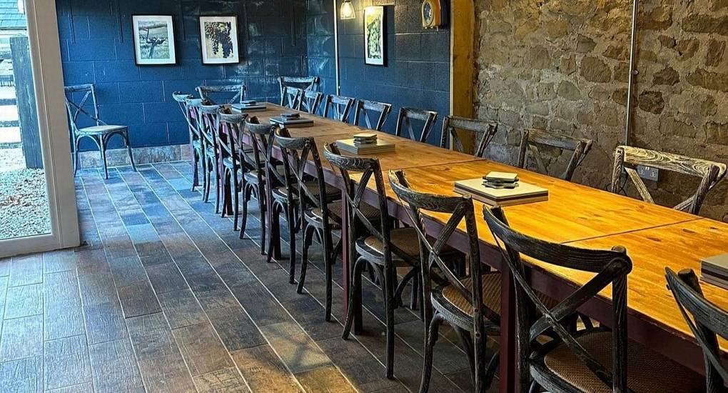 Long communal dining table at Lathkill Escape, perfect for large hen party celebrations and group dining.