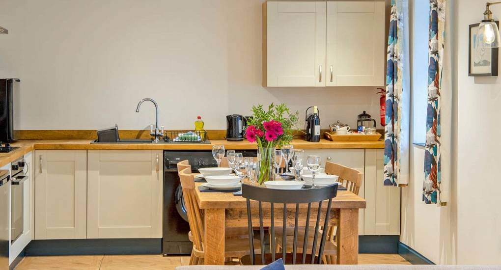Modern, fully equipped kitchen and breakfast table inside a Lathkill Escape luxury hen cottage.
